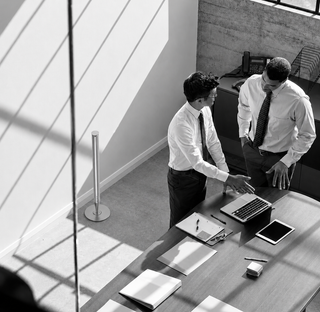 Two businessmen with the Venice Lux diffuser in an office, black and white lifestyle