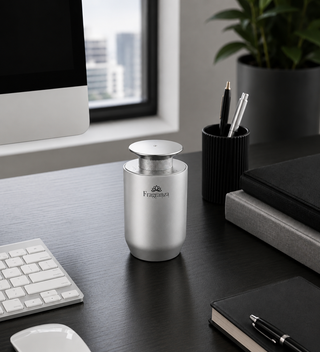 Silver Mini Pro diffuser on a desk beside a keyboard, lifestyle view