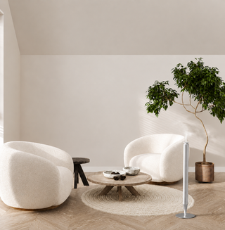 Silver Venice Lux diffuser beside a white armchair in a modern living room
